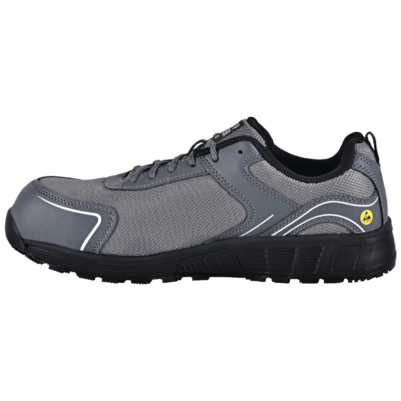 Grey athletic SAFETY JOGGER AAK S1P LOW sneaker with a black rugged sole and mesh upper, laces tied, side white trim lines visible.